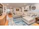 Spacious living room featuring hardwood floors, neutral paint, and large sectional sofa that makes relaxation easy at 1227 Seneca Pl, Charlotte, NC 28210