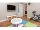 Playroom features hardwood floors, a wall-mounted TV, and an exercise bike at 1227 Seneca Pl, Charlotte, NC 28210