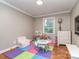 Playroom with hardwood floors, a window for natural light, and a play area for children at 1227 Seneca Pl, Charlotte, NC 28210