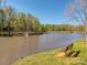 Picturesque pond featuring a wooden dock, lush greenery, and serene waters, perfect for leisurely strolls and relaxation at 1227 Seneca Pl, Charlotte, NC 28210