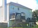 Back of house featuring large deck with gazebo, stairs to backyard, and vinyl siding at 12304 Sandringham Pl, Charlotte, NC 28262