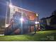 Well-maintained backyard featuring a two-level deck with lights and lush green grass at 12304 Sandringham Pl, Charlotte, NC 28262