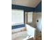 A bathroom with a tiled bathtub, shower with glass door, and the words 'Enjoy Relax' on the wall at 12304 Sandringham Pl, Charlotte, NC 28262
