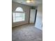 Bedroom featuring neutral carpeting, gray walls, a ceiling fan, and a window for natural light at 12304 Sandringham Pl, Charlotte, NC 28262