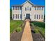 Traditional two-story home featuring manicured lawn and beautiful walkway leading to the front door at 12304 Sandringham Pl, Charlotte, NC 28262