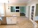 Open kitchen with a granite island and view into living room at 12304 Sandringham Pl, Charlotte, NC 28262