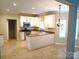 Well-lit kitchen with an island and stainless steel appliances at 12304 Sandringham Pl, Charlotte, NC 28262