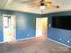 Spacious main bedroom with blue walls and two doorways at 12304 Sandringham Pl, Charlotte, NC 28262