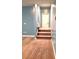Carpeted steps leading to a landing with an entrance door, set against blue walls at 12304 Sandringham Pl, Charlotte, NC 28262