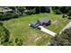 Aerial view of home featuring attached garage, long driveway, and large, well-maintained lawn at 125 Carter Ln, Statesville, NC 28625