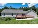 Well-maintained backyard features a wooden deck with wheelchair ramp and lush green grass at 125 Carter Ln, Statesville, NC 28625