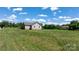 Spacious backyard with lush green grass surrounding the home, creating a serene outdoor space at 125 Carter Ln, Statesville, NC 28625