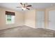 Well-lit bedroom with a ceiling fan, carpet flooring, and two closets for ample storage space at 125 Carter Ln, Statesville, NC 28625