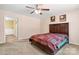 Well-lit bedroom with hardwood floors, ceiling fan, and an adjacent bathroom at 125 Carter Ln, Statesville, NC 28625