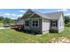 Detailed exterior showcasing neutral colors, white trim, a front porch ramp, and manicured landscaping at 125 Carter Ln, Statesville, NC 28625