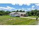 Exterior view of a charming single-story home featuring a detached garage and well-maintained lawn at 125 Carter Ln, Statesville, NC 28625