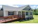 Detailed front exterior featuring a covered entryway ramp, neutral siding, and freshly cut grass at 125 Carter Ln, Statesville, NC 28625