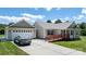 Exterior showcasing an attached garage, front entrance ramp, and well-maintained lawn on a sunny day at 125 Carter Ln, Statesville, NC 28625