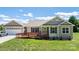 Charming home with a front ramp, neutral siding, attached garage, and manicured lawn at 125 Carter Ln, Statesville, NC 28625