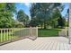 Back deck overlooking a spacious, well-maintained backyard, surrounded by mature trees, offering ample outdoor space at 1295 Patterson St, China Grove, NC 28023