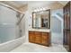 Bathroom with a shower-tub combination, neutral tile and a wood vanity with a large mirror at 1295 Patterson St, China Grove, NC 28023