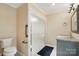 Bathroom featuring a glass shower, granite countertop vanity and low-flow toilet at 1295 Patterson St, China Grove, NC 28023