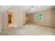 Large carpeted bedroom with a ceiling fan and a large window offering an abundance of natural light at 1295 Patterson St, China Grove, NC 28023
