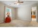 A simple bedroom features a window and a view into a bathroom with a wooden vanity at 1295 Patterson St, China Grove, NC 28023