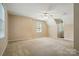 Spacious carpeted bedroom with a ceiling fan and a large window letting in natural light at 1295 Patterson St, China Grove, NC 28023