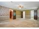 Spacious bedroom featuring patterned wallpaper, carpet flooring, a ceiling fan, and wooden trim at 1295 Patterson St, China Grove, NC 28023