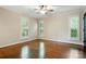 Bright bedroom with hardwood floors, white trim, and a ceiling fan at 1295 Patterson St, China Grove, NC 28023