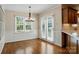 Dining room features wood floors, paneling, a modern chandelier and french doors at 1295 Patterson St, China Grove, NC 28023