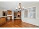 Dining room features wood floors, chandelier, and view to brick fireplace at 1295 Patterson St, China Grove, NC 28023