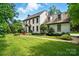 Traditional two-story home with beautiful lawn, manicured shrubs, and mature shade trees at 1295 Patterson St, China Grove, NC 28023