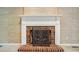 Close-up of a brick fireplace with decorative screen and white mantel at 1295 Patterson St, China Grove, NC 28023