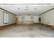 Spacious garage interior featuring storage cabinets, ceiling fans, and ample room for vehicles at 1295 Patterson St, China Grove, NC 28023