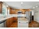 Bright kitchen with stainless appliances, wood cabinets, white counters, and kitchen island at 1295 Patterson St, China Grove, NC 28023