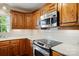 Kitchen features stainless steel appliances, wood cabinets, and white subway tile backsplash at 1295 Patterson St, China Grove, NC 28023