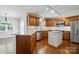 Eat-in kitchen features stainless appliances, white quartz counters, wood cabinets and island at 1295 Patterson St, China Grove, NC 28023