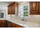 Bright kitchen sink with stainless fixtures, white counters, and tile backsplash at 1295 Patterson St, China Grove, NC 28023