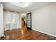 Bright living room featuring hardwood floors, natural light, and a modern glass door leading to the kitchen at 1295 Patterson St, China Grove, NC 28023