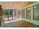 Covered screened-in porch features natural wood floors and ceiling offering an inviting outdoor space at 1295 Patterson St, China Grove, NC 28023