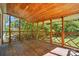 Screened-in porch showcasing an exposed wood ceiling and decorative railing, perfect for outdoor relaxation at 1295 Patterson St, China Grove, NC 28023