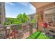 Open-air balcony featuring a gas grill, green turf, and views of the lush surroundings at 1315 East Blvd # 410, Charlotte, NC 28203