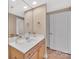 Bright bathroom with a single sink vanity and a large mirror creating an open, airy feel at 1315 East Blvd # 410, Charlotte, NC 28203