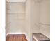 Walk-in closet featuring a built-in shelving system and wood-look flooring at 1315 East Blvd # 410, Charlotte, NC 28203