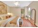 Comfortable bedroom features a large bed with soft pillows, window view, and a full length mirror at 1315 East Blvd # 410, Charlotte, NC 28203