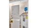 Small utility room featuring a stacked washer and dryer, water heater, and utility shelving at 1315 East Blvd # 410, Charlotte, NC 28203