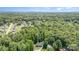 A serene aerial view shows the property nestled among mature trees in the surrounding neighborhood at 1318 Candlewood Dr, Gastonia, NC 28052
