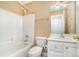 Well-maintained bathroom features a shower-tub combo, white vanity, tile floor, and updated fixtures at 1318 Candlewood Dr, Gastonia, NC 28052